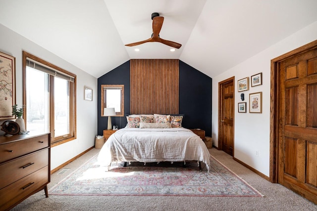 bedroom featuring visible vents, light colored carpet, baseboards, and vaulted ceiling