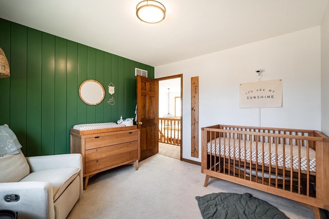 carpeted bedroom with visible vents and a nursery area