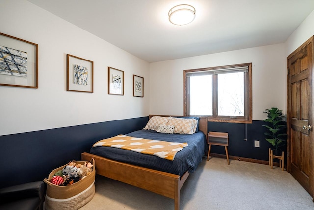 bedroom featuring baseboards and carpet flooring