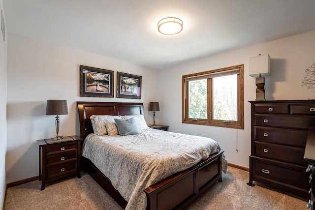 bedroom featuring baseboards and light carpet