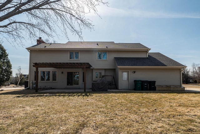 back of property featuring a patio area, a lawn, and a chimney