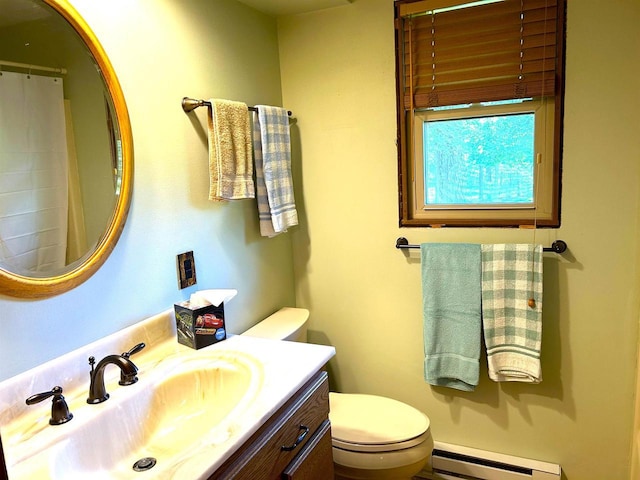 bathroom featuring vanity, toilet, and baseboard heating