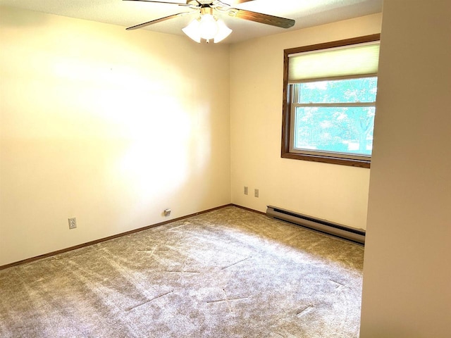 carpeted spare room featuring a ceiling fan, baseboards, and a baseboard radiator