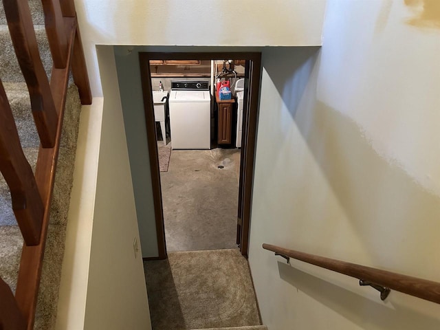 stairs featuring washer and dryer and carpet