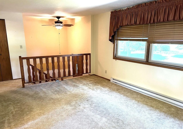 unfurnished room with a baseboard radiator, carpet, and ceiling fan