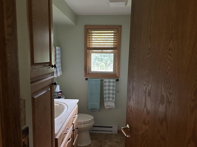 bathroom with vanity, toilet, and a baseboard radiator