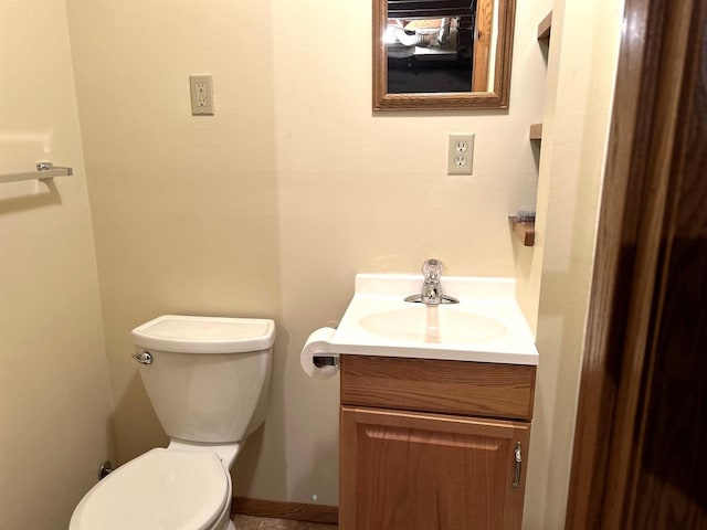 bathroom featuring toilet and vanity