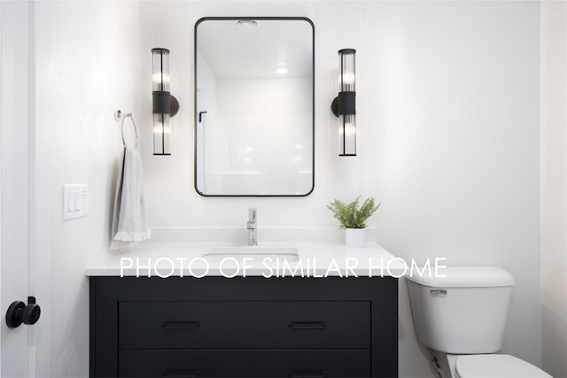 bathroom featuring toilet and vanity