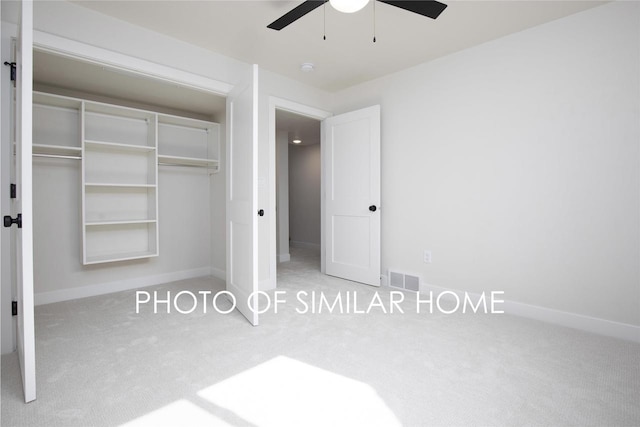 unfurnished bedroom with a ceiling fan, visible vents, baseboards, a closet, and carpet flooring