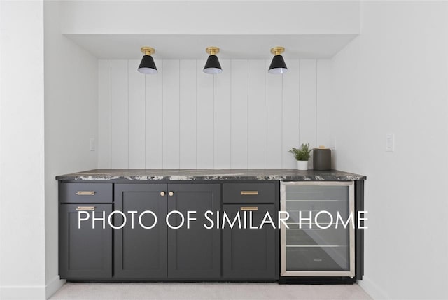 interior details featuring wine cooler and baseboards