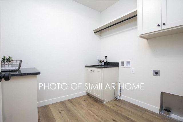 washroom with hookup for an electric dryer, light wood-type flooring, baseboards, and washer hookup