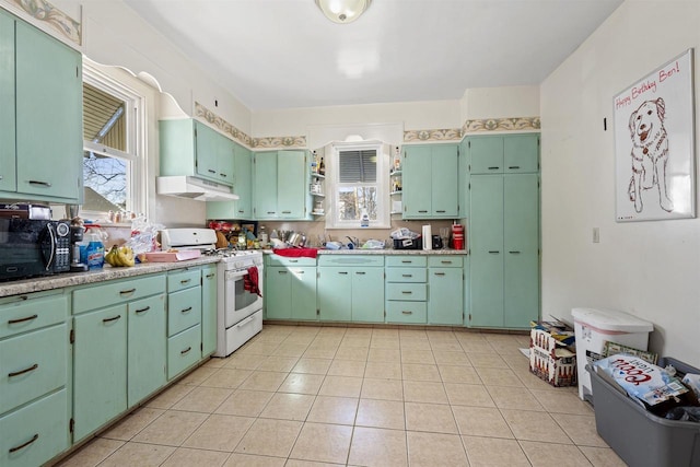 kitchen with open shelves, gas range gas stove, light countertops, under cabinet range hood, and black microwave