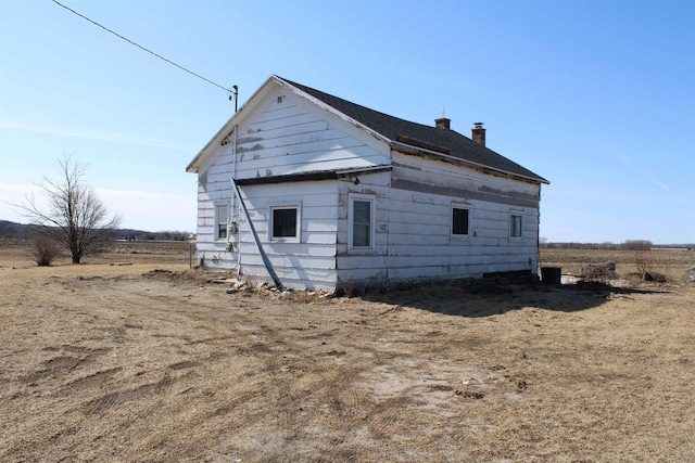 view of side of property featuring a chimney