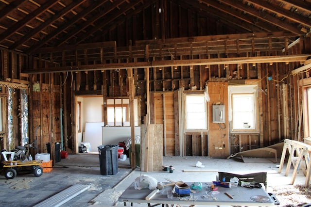 misc room featuring vaulted ceiling and electric panel