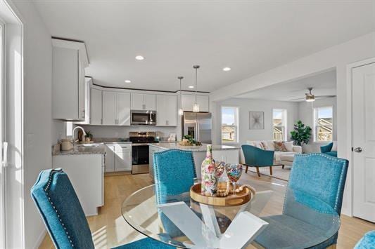 dining space with recessed lighting and light wood-style floors