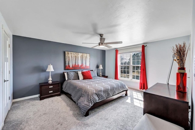 carpeted bedroom with baseboards and ceiling fan