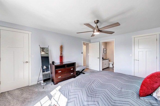 carpeted bedroom with a ceiling fan and ensuite bathroom