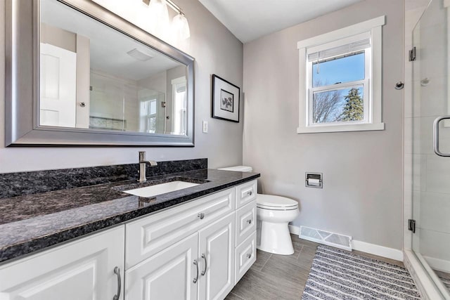 bathroom featuring toilet, visible vents, and a stall shower