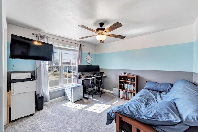 office space with a ceiling fan, carpet, and baseboards