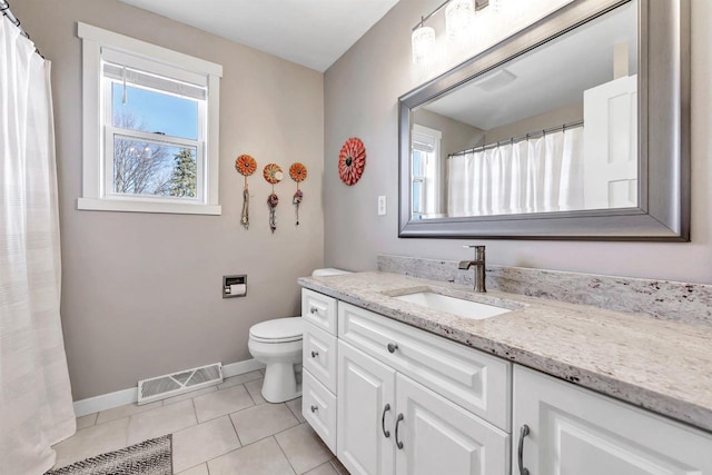 bathroom featuring tile patterned floors, visible vents, a healthy amount of sunlight, and vanity