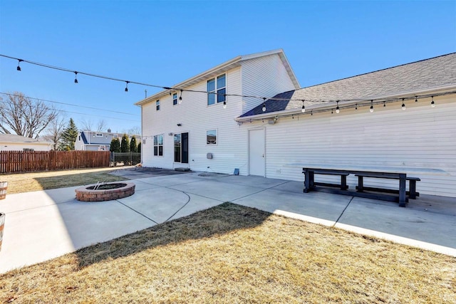 back of house featuring a patio area, a fire pit, and fence