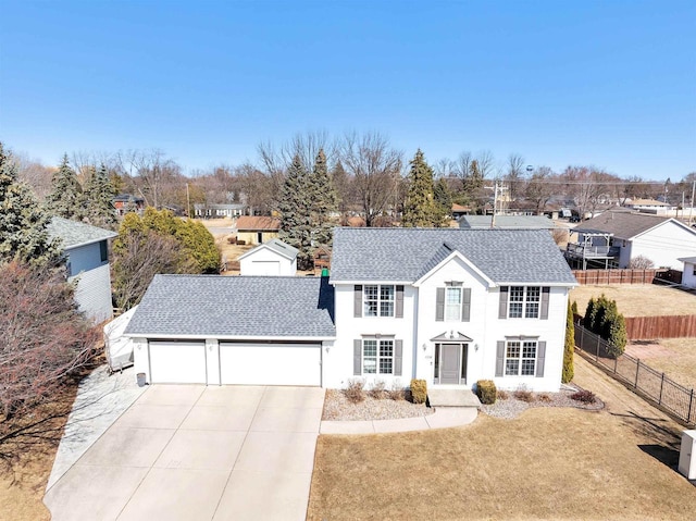 view of front facade with fence, driveway, roof with shingles, an attached garage, and a front lawn