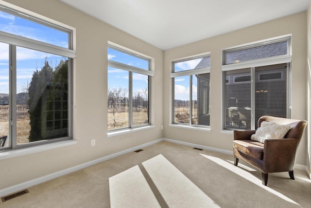 sitting room featuring carpet flooring, baseboards, and visible vents