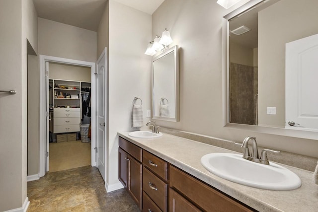 full bathroom featuring a sink, visible vents, a spacious closet, and double vanity