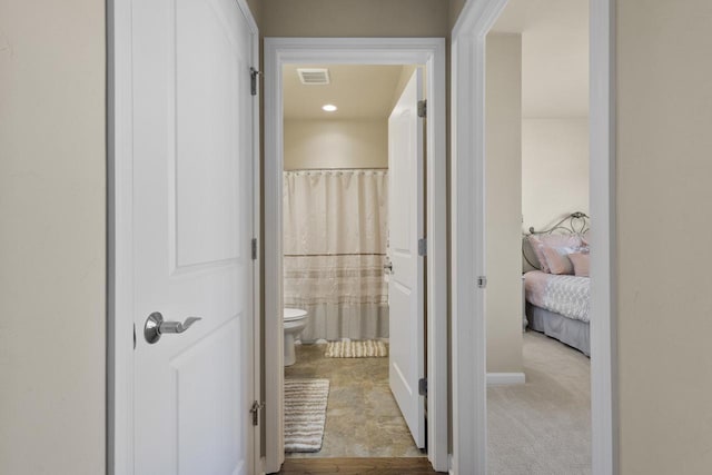 hallway featuring carpet and visible vents