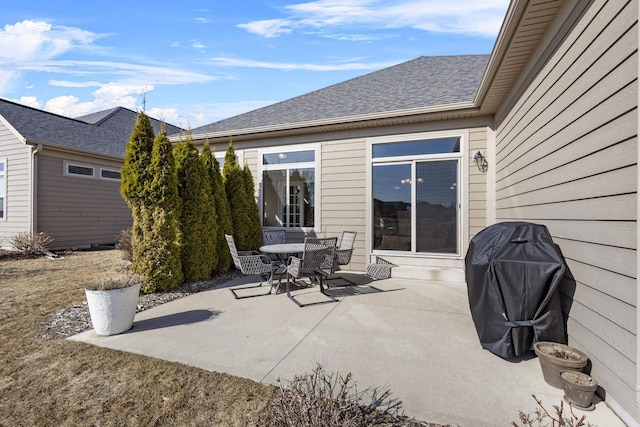 view of patio with area for grilling and outdoor dining area