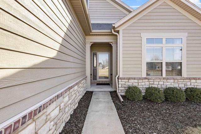 entrance to property featuring stone siding