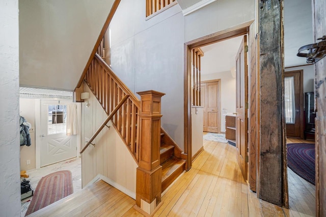 stairs featuring hardwood / wood-style floors