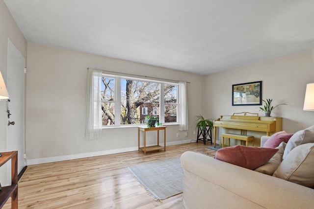 living room featuring baseboards and wood finished floors