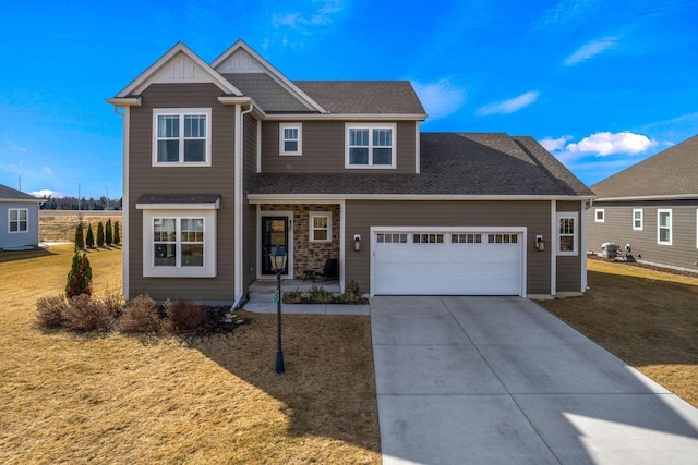 view of front of house with a garage, a front lawn, roof with shingles, and driveway