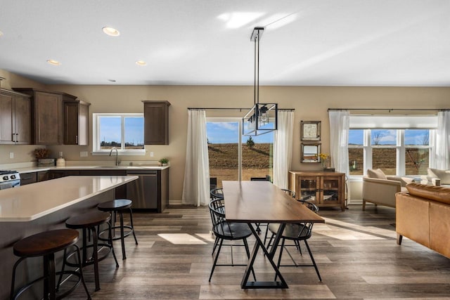 dining room featuring recessed lighting, baseboards, plenty of natural light, and dark wood-type flooring