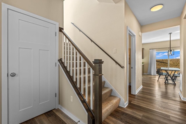 stairway with baseboards and wood finished floors