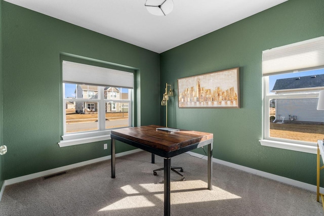 carpeted office featuring baseboards and visible vents