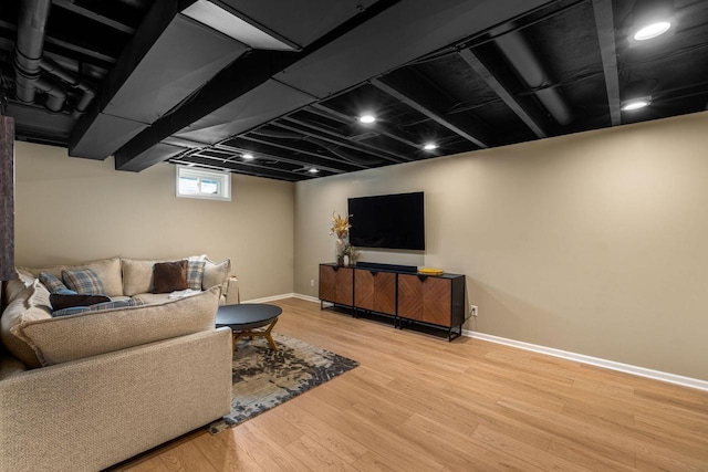 living area with wood finished floors and baseboards