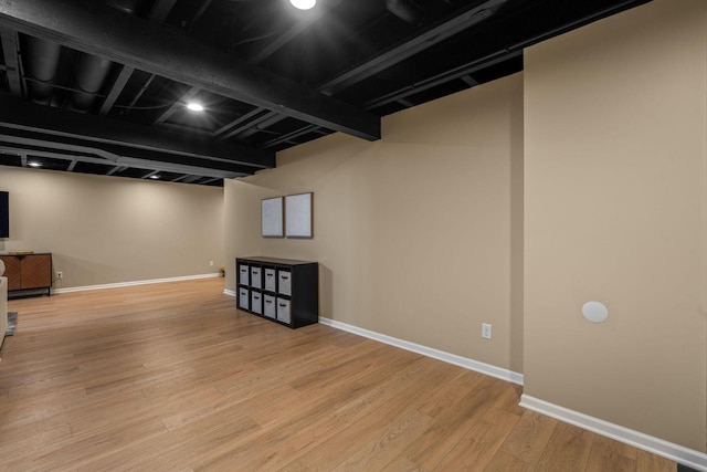 finished basement featuring wood finished floors and baseboards