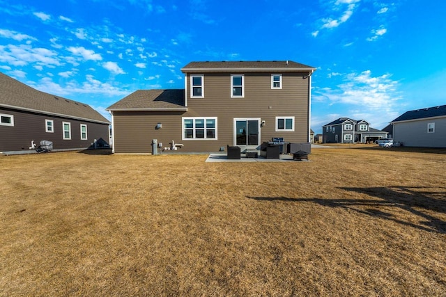 rear view of property featuring a yard, a patio, and outdoor lounge area