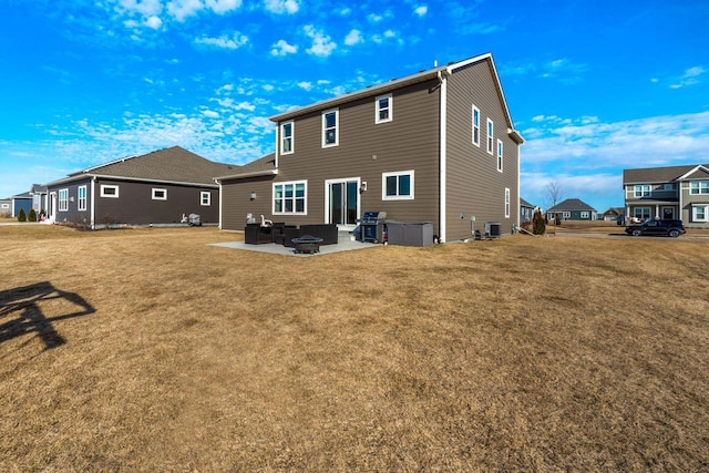 rear view of house featuring a patio, central AC unit, and a lawn