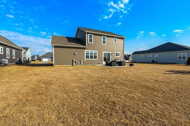 back of property with a patio and a yard