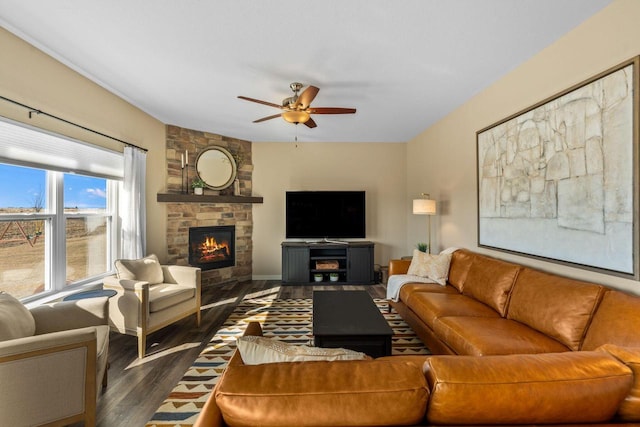 living room with a fireplace, ceiling fan, and dark wood-style flooring