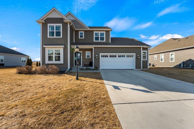 view of front facade featuring a front yard, an attached garage, board and batten siding, and driveway