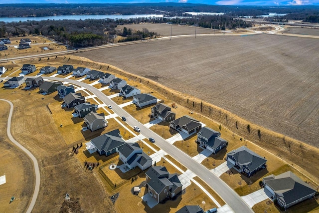 drone / aerial view with a residential view and a water view