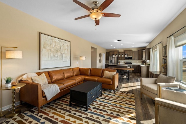 living room featuring recessed lighting, baseboards, wood finished floors, and a ceiling fan