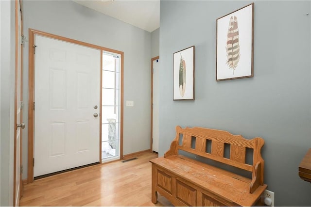 foyer featuring light wood-style flooring, a healthy amount of sunlight, and visible vents