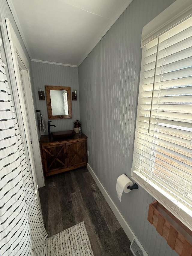 3743 S Milton Shopiere Rd, Janesville, WI 53546 - bathroom featuring baseboards, vanity, wood finished floors, and crown molding