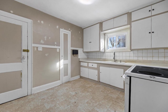 kitchen with white cabinetry, white electric range, and a sink