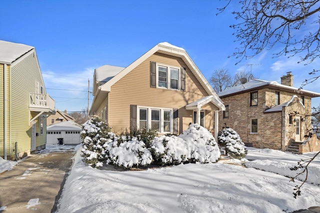 view of front of property featuring a garage and an outdoor structure